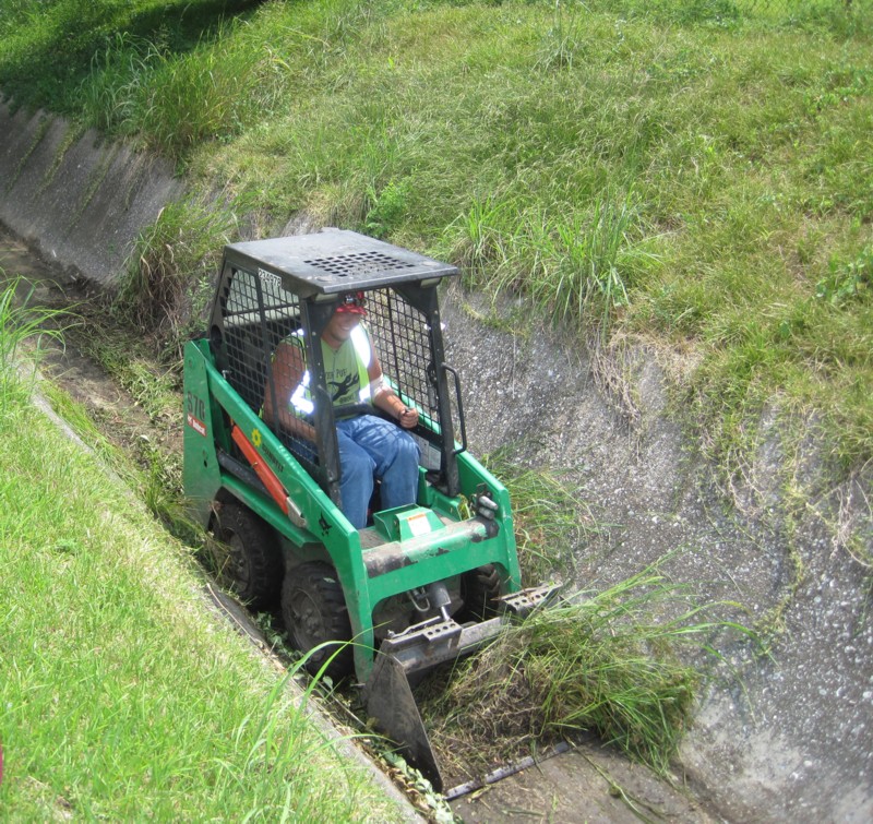 Worker clearing a ditch