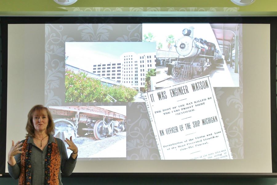 Kathleen Maca, author, presenting in front of project for Haunted Galveston